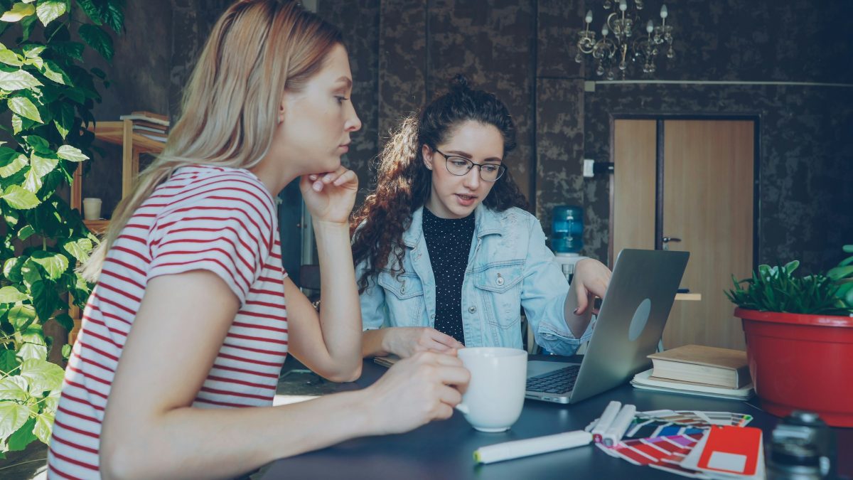 Best Applicant Tracking Systems (ATS) in 2026: Compared & Ranked | Think Daily 1 two women discuss something on a laptop